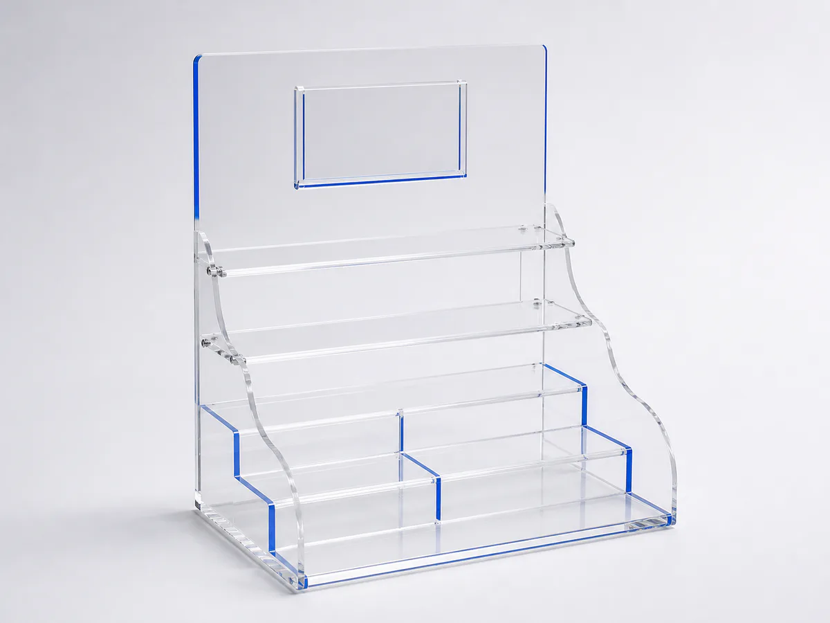Concept visualization of a clear acrylic POP countertop display with tiered product risers